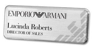 A silvered plastic executive name badge with the leyend: "Emporio Armani"